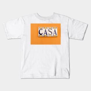 Village street in old Spanish town with Spanish word CASA in tiles on orange wall Kids T-Shirt